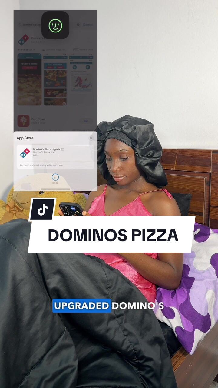 VA in a pink top holding her phone, Domino's Pizza caption